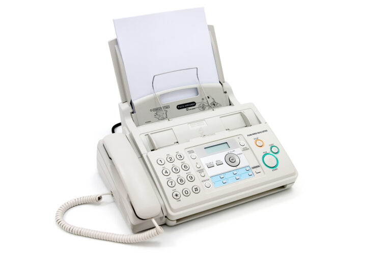 a desktop fax machine that uses paper it's white and has a handset and phone buttons.